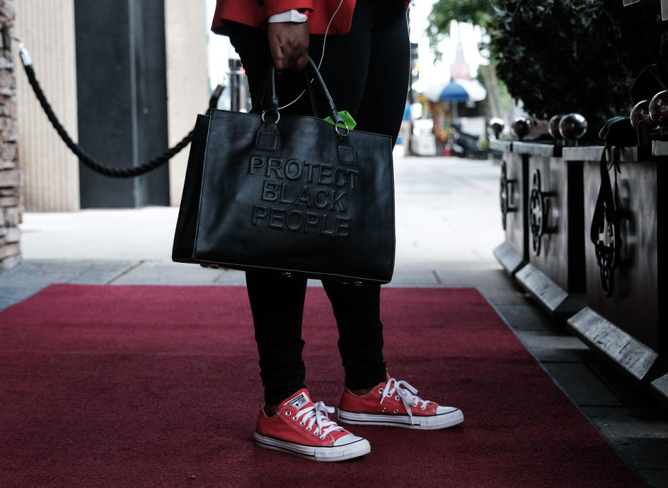 Texas Representative Jasmine Crockett holds a handbag with the words “Protect Black People” in Washington, D.C., on July 16.<span class="copyright">Michael A. McCoy for TIME</span>