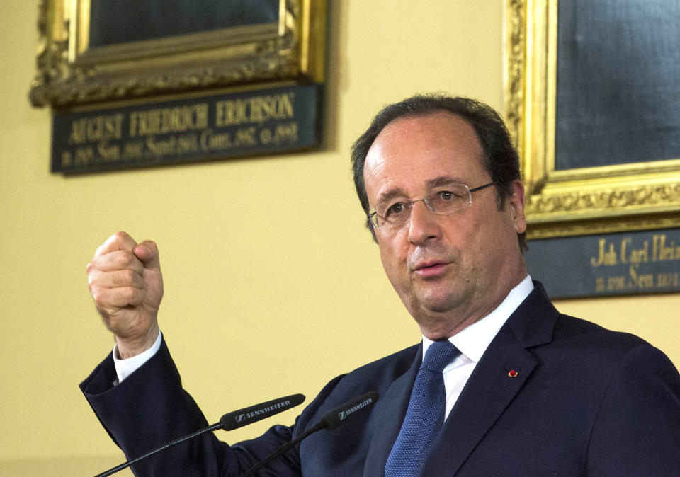 French President Francois Hollande gestures during a news conference with German Chancellor Merkel at the town hall in Stralsund, northern Germany, Saturday, May 10, 2014 during the second day of Hollande's two days visit to Merkel's scenic home constituency on the Baltic coast . One of the main talking points is expected to be over whether the European Union should impose further sanctions on Russia, for its involvement in the Ukraine crisis. (AP Photo/Gero Breloer)