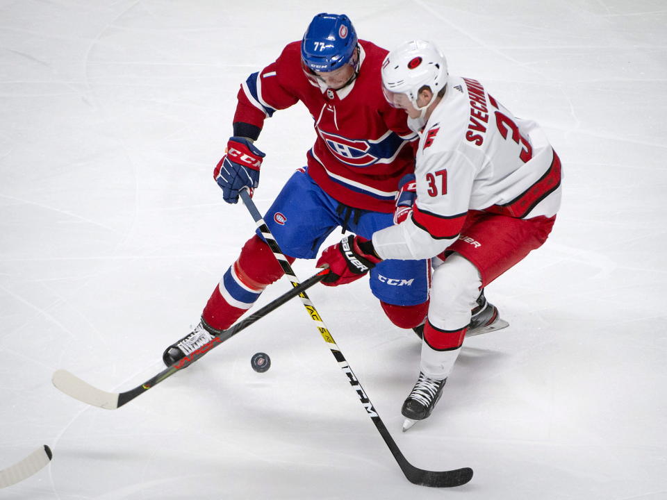 Montreal Canadiens defenseman Brett Kulak (77) and Carolina Hurricanes right wing Andrei Svechnikov (37) vie for control of the puck during the second period of an NHL hockey game Saturday, Feb. 29, 2020, in Montreal. (Peter McCabe/The Canadian Press via AP)