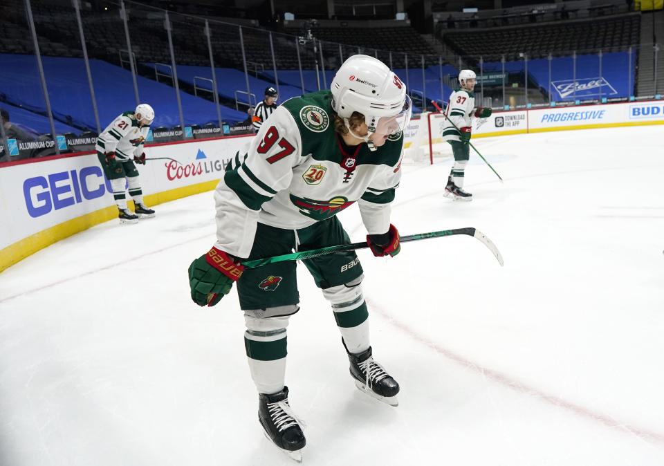 Minnesota Wild left wing Kirill Kaprizov, front, defenseman Carson Soucy, back left, and center Kyle Rau react at the end of the team's NHL hockey game against the Colorado Avalanche on Tuesday, Feb. 2, 2021, in Denver. (AP Photo/David Zalubowski)