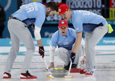 Curling - Pyeongchang 2018 Winter Olympics - Men's Final - Sweden v U.S. - Gangneung Curling Center - Gangneung, South Korea - February 24, 2018 - Skip John Shuster of the U.S. watches the shot as his teammates, lead John Landsteiner and second Matt Hamilton, sweep. REUTERS/John Sibley