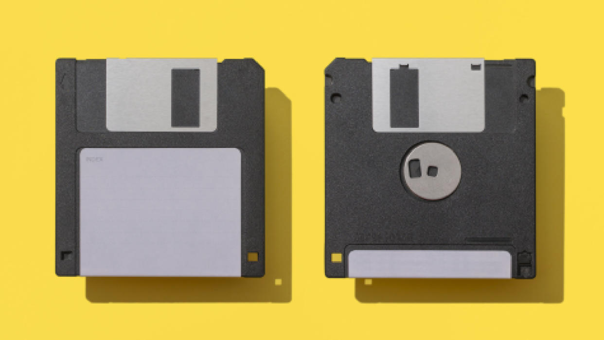  Close-Up Of Two Floppy Disks Against Yellow Background. 