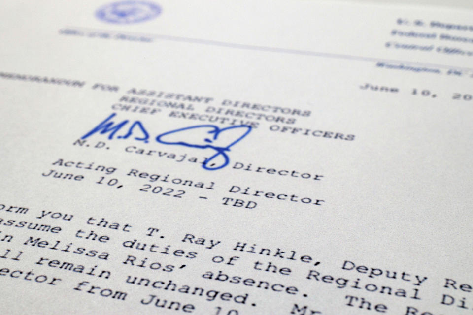 A June 10, 2022 memorandum sent to Bureau of Prisons staff by then-Director Michael Carvajal announcing Thomas Ray Hinkle's promotion to acting regional director of the agency's western region is photographed on Nov. 21, 2022. Hinkle, a senior official at the federal Bureau of Prisons has been repeatedly promoted, most recently to one of the highest posts in the agency. And this has happened despite his being accused of beating multiple Black inmates in the 1990s. An Associated Press investigation has found the Bureau of Prisons has continued to promote Hinkle despite numerous red flags. (AP Photo/Jon Elswick)