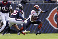 Chicago Bears running back Khalil Herbert (24) runs for a gain as Houston Texans safety Jonathan Owens (36) defends during the first half of an NFL football game Sunday, Sept. 25, 2022, in Chicago. (AP Photo/Nam Y. Huh)