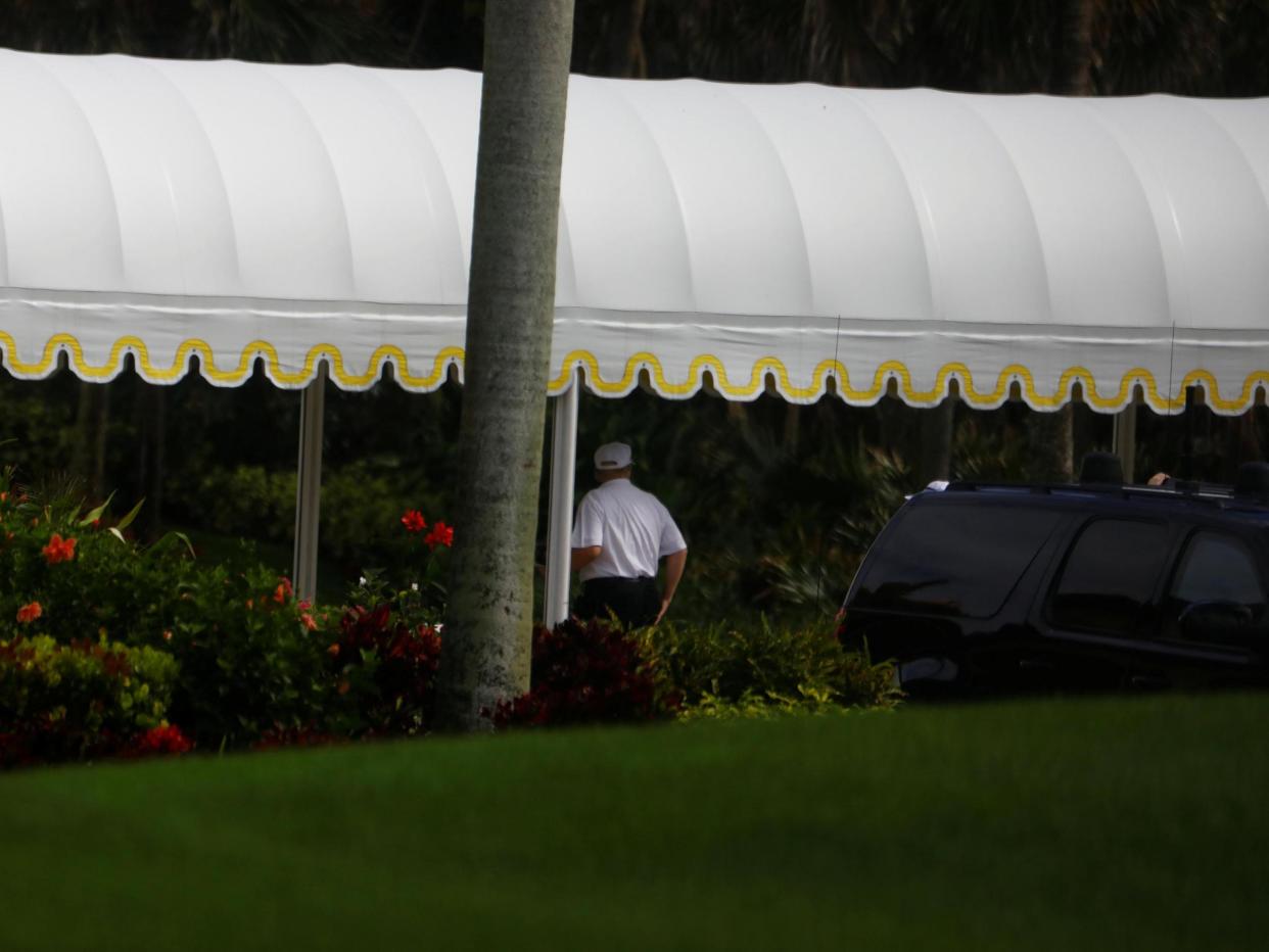 The President appeared to be dressed for a round as he arrived at his Mar-a-Lago estate in Palm Beach, Florida: REUTERS