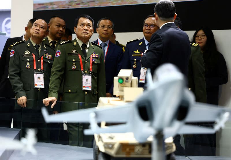 FILE PHOTO: Cambodia’s Armed Forces Commander-in-chief Vong Pisen tours the Aviation Industry Corporation of China (AVIC) booth during the Singapore Airshow at Changi Exhibition Centre in Singapore