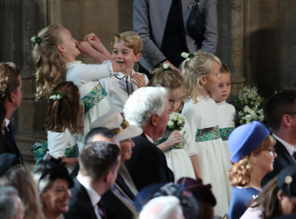 The bridesmaids and page boys, including Princess Charlotte of Cambridge (L), Savannah Phillips (2L) and Prince George of Cambridge (3L) wait to take part in the wedding of Britain's Princess Eugenie of York to Jack Brooksbank at St George's Chapel, Windsor Castle, in Windsor, on October 12, 2018. (Photo by Yui Mok / POOL / AFP) (Photo credit should read YUI MOK/AFP/Getty Images)