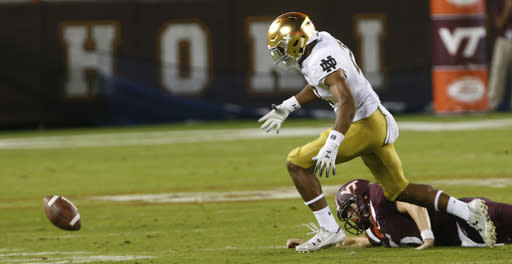 Notre Dame cornerback Julian Love (27) heads for the fumble as Virginia Tech quarterback Ryan Willis (5) watches during the first half of an NCAA college football game in Blacksburg, Va., Saturday, Oct. 6, 2018. Love recovered the ball and ran for a touchdown. (AP Photo/Steve Helber)