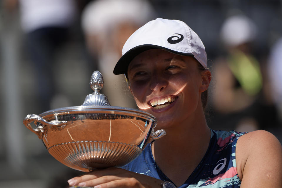 Poland's Iga Swiatek holds the trophy after winning the final match against Turkey's Ons Jabeur at the Italian Open tennis tournament, in Rome, Sunday, May 15, 2022. (AP Photo/Alessandra Tarantino)