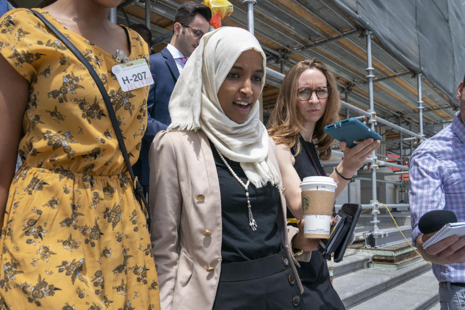 Rep. Ilhan Omar, D-Minn., a target of racist rhetoric from President Donald Trump, walks from the House to her office following votes, at the Capitol in Washington, Thursday, July 18, 2019. (AP Photo/J. Scott Applewhite)