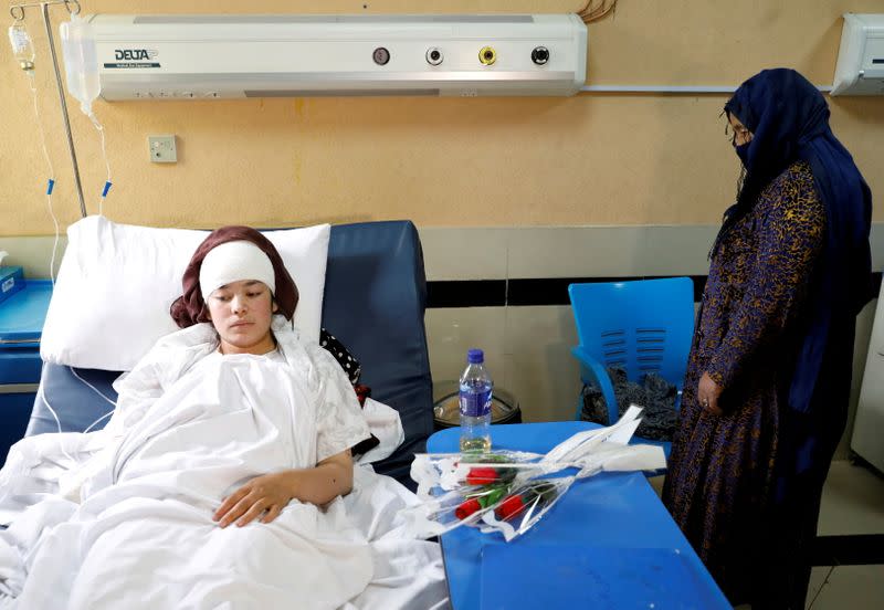 FILE PHOTO: A schoolgirl who was injured in a car bomb blast outside a school on Saturday, receives treatment at a hospital in Kabul