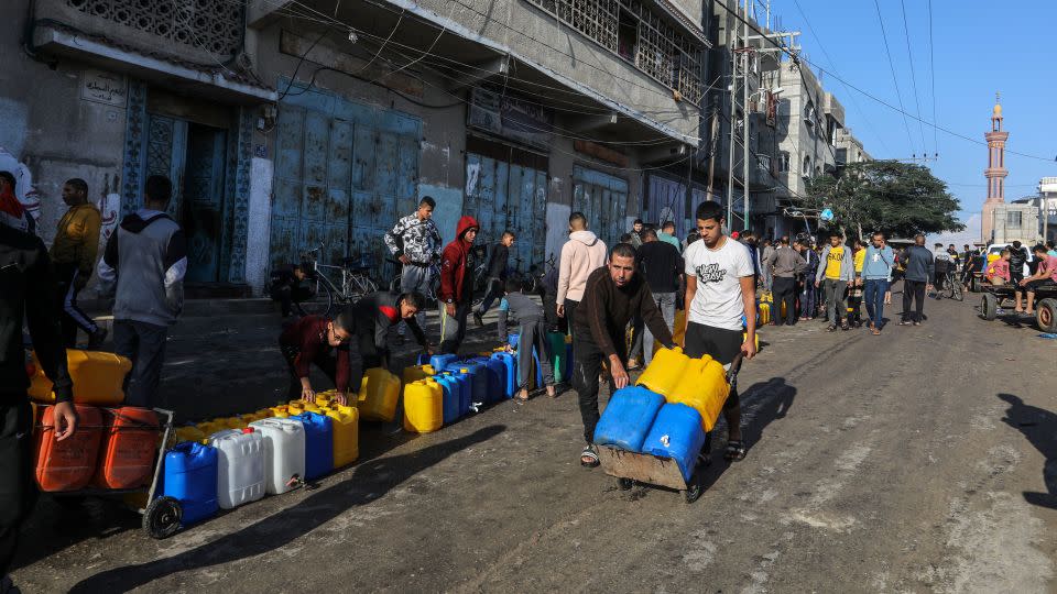 Palestinians queue to receive clean water from a water station. (Photo by Abed Rahim Khatib/picture alliance via Getty Images) - Abed Rahim Khatib/picture alliance/Getty Images