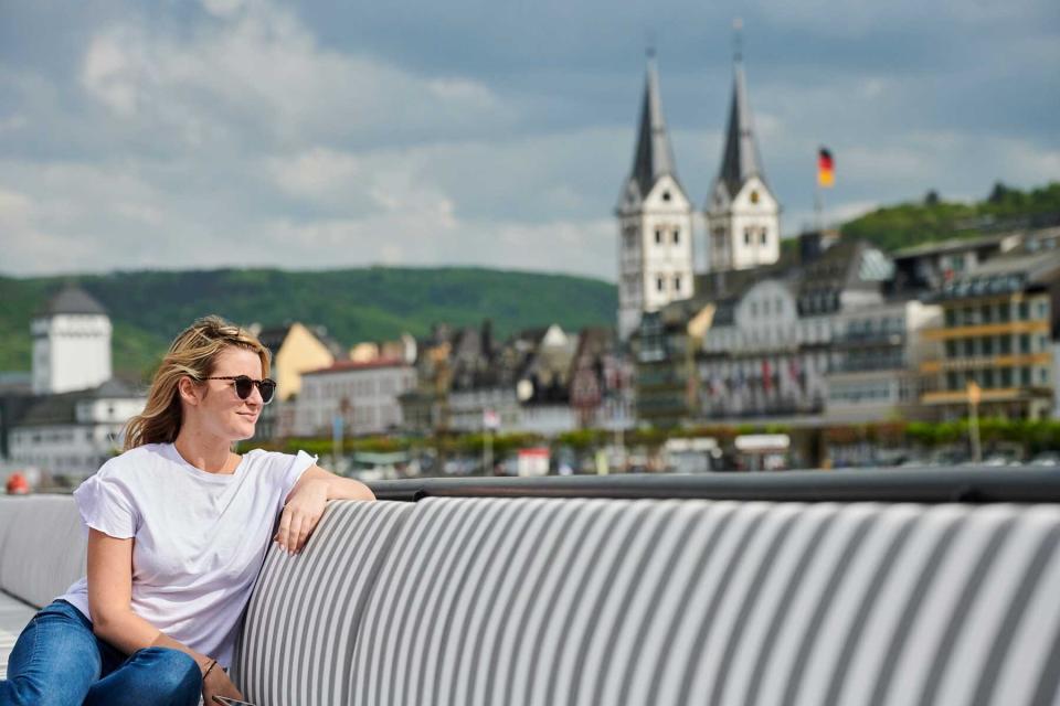 Young woman on the deck of a U by Uniworld river cruise ship sailing the Rhine River