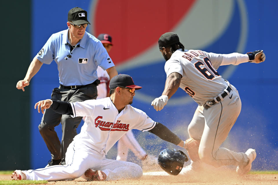 Detroit Tigers' Akil Baddoo (60) steals second base against Cleveland Guardians' Andrés Giménez during the seventh inning of a baseball game, Sunday, Aug. 20, 2023, in Cleveland. (AP Photo/Nick Cammett)