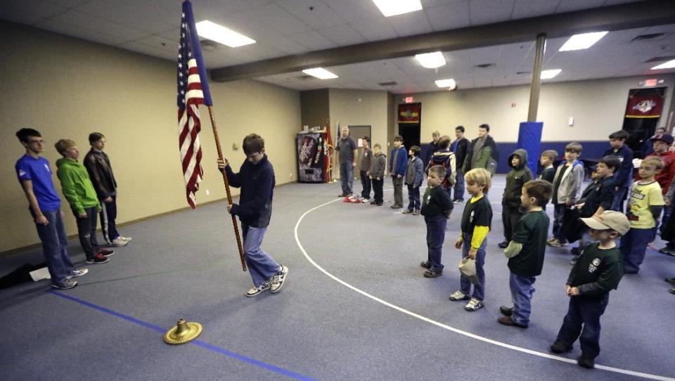 In this Tuesday, Feb. 4, 2014 photo, Trail Life members present a U.S. flag at the opening of meeting in North Richland Hills, Texas. Trail Life USA, the new Christian-based alternative to the Boy Scouts of America, excludes openly gay members. (AP Photo/LM Otero)