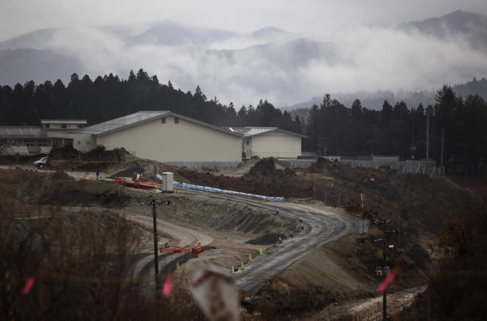 In this Wednesday, March 5, 2014 photo, access roads to new housing grounds are seen in Rikuzentakata, Miyagi Prefecture, northeastern Japan. In the city which lost half of its homes in the disaster and is using soil from mountains being flattened to make space to raise lowland areas for rebuilding, the first 120-unit disaster housing complex will be ready by September. (AP Photo/Junji Kurokawa)