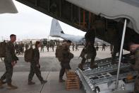 Marines board a KC-130J Hercules aircraft at the U.S. Futenma airbase in Ginowan, on the southern Japanese island of Okinawa, November 10, 2013 in this handout provided by U.S. Marine Corps. A team of about 90 U.S. Marines and sailors headed to the Philippines on Sunday, part of a first wave of promised U.S. military assistance for relief efforts after a devastating typhoon killed at least 10,000 people, U.S. officials said. Defense Secretary Chuck Hagel this weekend ordered the U.S. military's Pacific Command to assist with search and rescue operations and provide air support in the wake of super typhoon Haiyan, one of the most powerful storms ever recorded. Picture taken November 10, 2013. REUTERS/Lance Cpl. David N. Hersey/U.S. Marine Corps/Handout via Reuters (JAPAN - Tags: DISASTER MILITARY POLITICS) FOR EDITORIAL USE ONLY. NOT FOR SALE FOR MARKETING OR ADVERTISING CAMPAIGNS. THIS IMAGE HAS BEEN SUPPLIED BY A THIRD PARTY. IT IS DISTRIBUTED, EXACTLY AS RECEIVED BY REUTERS, AS A SERVICE TO CLIENTS