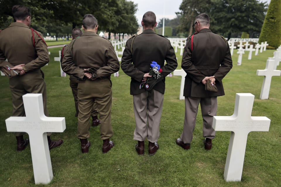 World War II history enthusiasts pay respect in the US cemetery of Colleville-sur-Mer, Normandy, Saturday, June, 4 2022. Several ceremonies will take place to commemorate the 78th anniversary of D-Day that led to the liberation of France and Europe from the German occupation. (AP Photo/Jeremias Gonzales)