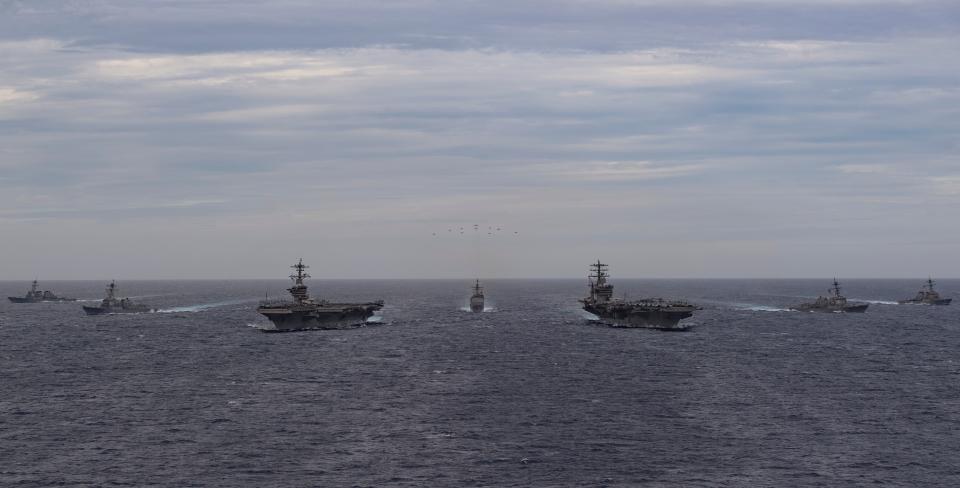 The Theodore Roosevelt and Nimitz Carrier Strike Groups steam in formation on scheduled deployments to South China Sea.