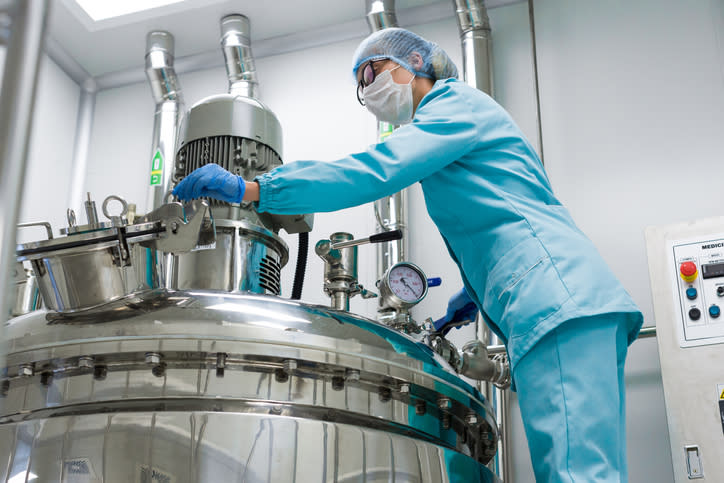 A technician servicing a bioreactor.