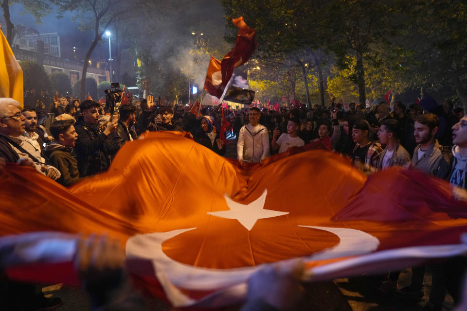 Supporters of President Recep Tayyip Erdogan celebrate outside AKP (Justice and Development Party) headquarters in Istanbul, Turkey, Sunday, May 14, 2023. More than 64 million people, including 3.4 million overseas voters, were eligible to vote. (AP Photo/Khalil Hamra)