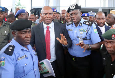 Suspended senator Ovie Omo-Agege is seen flanked by police at the parliament building in Abuja, Nigeria April 18, 2018. REUTERS/ Camillus Eboh