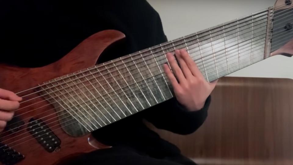 YouTuber Ichika Nito strums on a 14-string guitar.