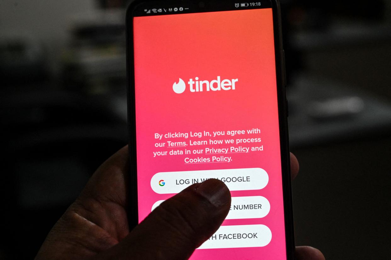 In this photo illustration taken on Oct. 6, 2020, a user checks the dating app Tinder on a mobile phone in Islamabad.