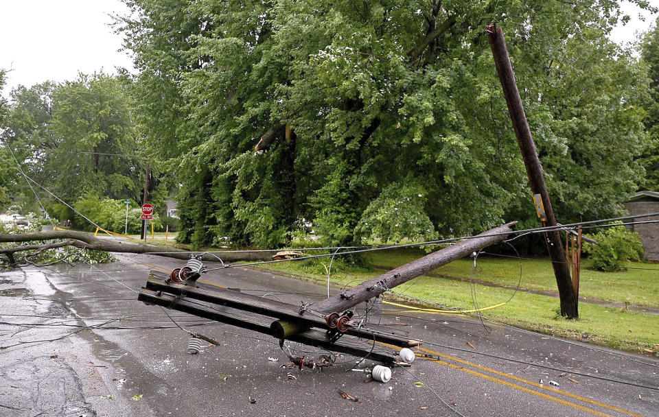 Traffic is rerouted due to a downed power line near the intersection of Brown and College avenues in Terre Haute, Ind., on Thursday, June 29, 2023 after damaging winds moved through the Wabash Valley. Utility crews were scrambling Friday to restore electricity after a storm front moved across Illinois and Indiana on Thursday packing winds topping 70 miles an hour at times. (Joseph C. Garza/The Tribune-Star via AP)