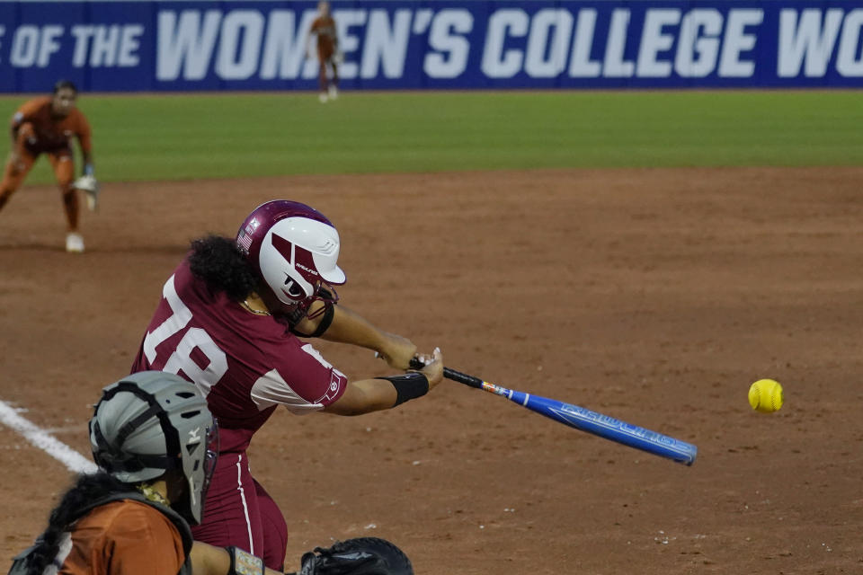 Oklahoma's Jocelyn Alo hits a single against Texas during the sixth inning of the second game of the NCAA Women's College World Series softball championship series Thursday, June 9, 2022, in Oklahoma City. (AP Photo/Sue Ogrocki)