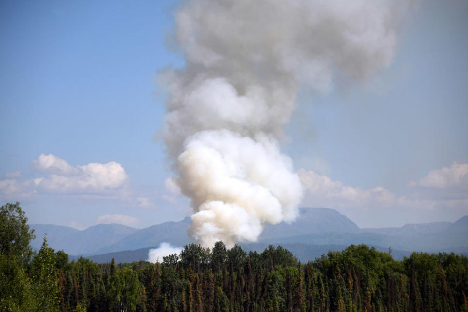 Smoke rises from a wildfire on July 3, 2019 south of Talkeetna, Alaska near the George Parks Highway. Alaska is bracing for a dangerous fire season with record warm temperatures and dry conditions in parts of the state. | Lance King—Getty Images