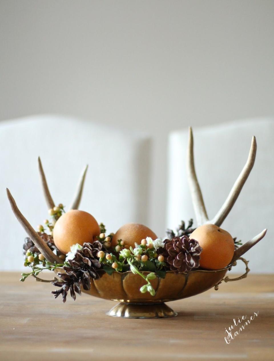 <p>Most of the components in this centerpiece can be found in your backyard, making it quick to assemble. Pick up faux antlers at the craft store for a final flourish.</p><p><em><a href="http://julieblanner.com/5-minute-thanksgiving-centerpiece/" rel="nofollow noopener" target="_blank" data-ylk="slk:Get the tutorial at Julie Blanner »;elm:context_link;itc:0;sec:content-canvas" class="link ">Get the tutorial at Julie Blanner »</a></em></p>