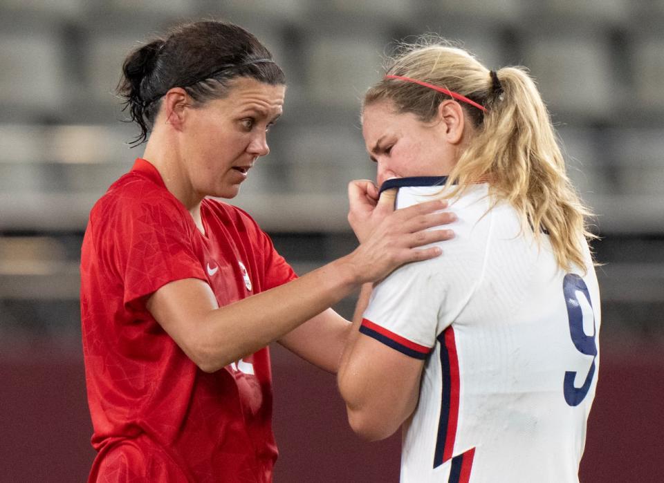 Team Canada forward Christine Sinclair (12) consoles Team United States midfielder Lindsey Horan (9) after their semifinal football game at the Tokyo Olympics in Kashima, Japan, Monday, Aug. 2, 2020. THE CANADIAN PRESS/ Frank Gunn