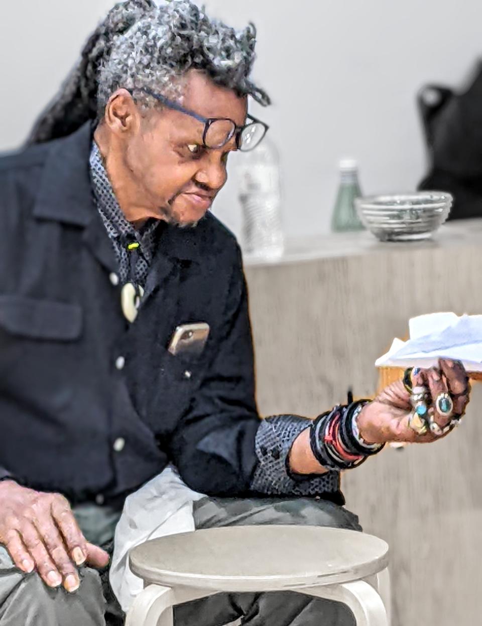 Artist Lonnie Holley and a paper airplane.