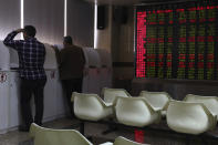 Investors monitor stock prices on terminals at a brokerage in Beijing, China, Friday, Nov. 16, 2018. (AP Photo/Ng Han Guan)