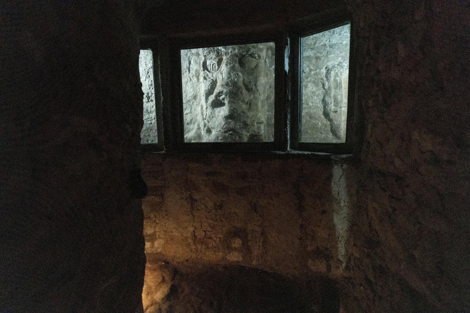 A stucco mask, part of the substructure "Rosalila," is seen through a window inside Temple 16, the central building of the Acropolis of Copan, an ancient Maya site in western Honduras, Saturday, Sept. 23, 2023. (AP Photo/Moises Castillo)