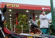 Nurse Jose Bueno waits in line to get fuel in front of a gas station, during a nationwide quarantine due to the coronavirus disease (COVID-19) outbreak, in Caracas