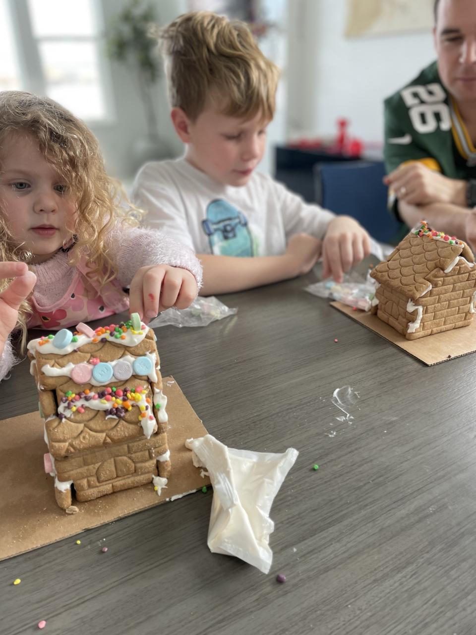 the author's family decorating gingerbread houses