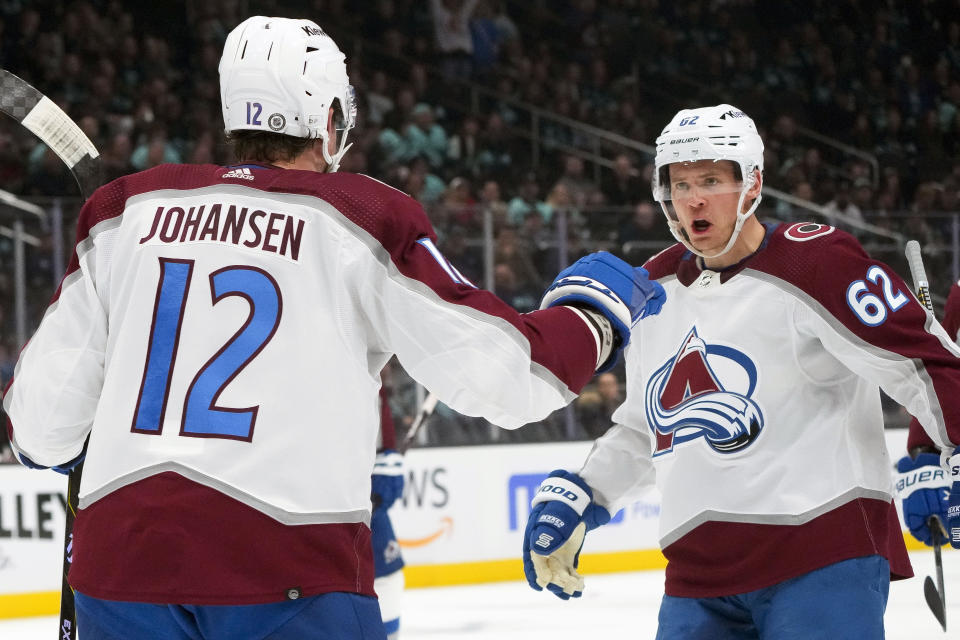 Colorado Avalanche left wing Artturi Lehkonen (62) reacts after scoring against the Seattle Kraken with teammate Ryan Johansen (12) during the second period of an NHL hockey game Tuesday, Oct. 17, 2023, in Seattle. (AP Photo/Lindsey Wasson)