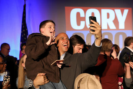 U.S. Senator Cory Booker (D-NJ) takes photos with supporters after speaking during his 2020 U.S. presidential campaign in Des Moines, Iowa, U.S., February 9, 2019. REUTERS/Scott Morgan