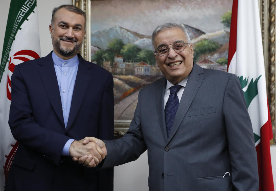 Iranian Foreign Minister Hossein Amirabdollahian, left, shakes hands with his Lebanese counterpart Abdullah Bou Habib, in Beirut, Lebanon, Thursday, Oct. 7, 2021. Amirabdollahian is in Beirut to meet with Lebanese officials. (AP Photo/Hussein Malla)