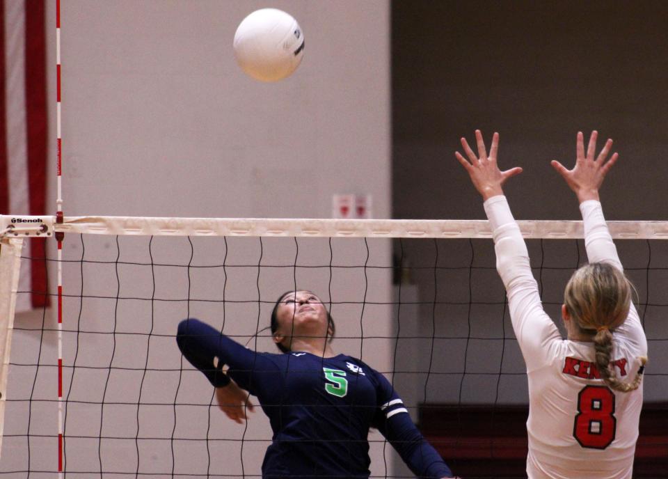 Beachside's Erica Duffy (5) leaps to spike the ball as Bishop Kenny's Claudia Stockard (8) defends during a Sept. 20 match.