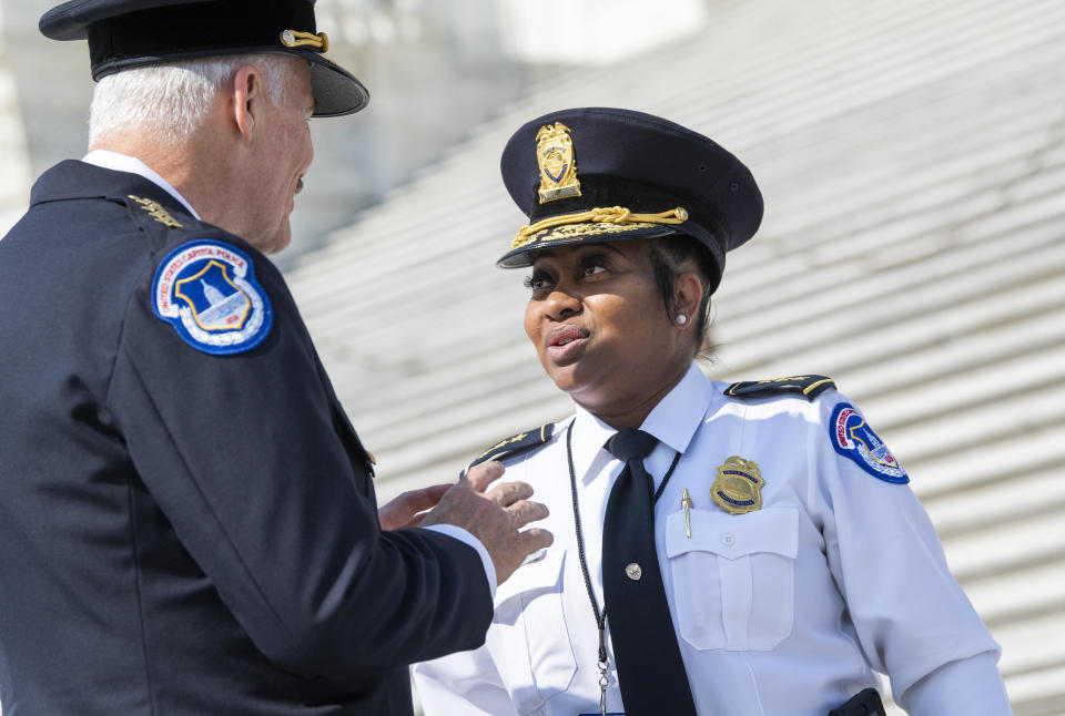 Manger, the new chief of the U.S. Capitol Police, talks with former acting Chief Yogananda Pittman, after Manger was sworn in as chief at the Senate steps of the Capitol on Friday. / Credit: Tom Williams/CQ-Roll Call, Inc via Getty Images