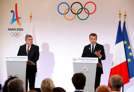 French President Emmanuel Macron (R) and President of the International Olympic Committee (IOC) Thomas Bach (L) attend a press conference during their visit at the future site of the sailing for the 2024 Summer Olympic Games in Marseille, France, September 21, 2017. REUTERS/Sebastien Nogier/Pool