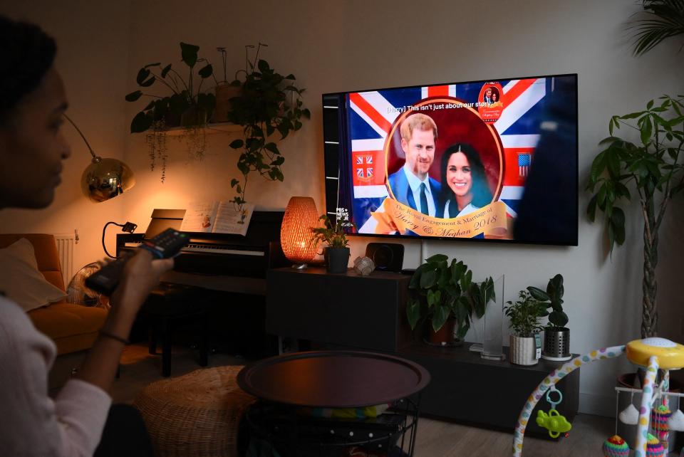 TOPSHOT - A woman poses as she watches an episode of the newly released Netflix docuseries 