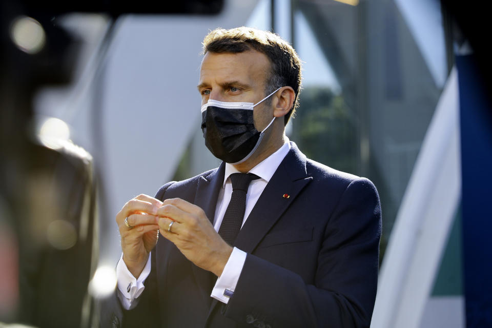 French President Emmanuel Macron speaks with the media as he arrives for an EU summit at the Crystal Palace in Porto, Portugal, Saturday, May 8, 2021. On Saturday, EU leaders hold an online summit with India's Prime Minister Narendra Modi, covering trade, climate change and help with India's COVID-19 surge. (Violeta Santos Moura, Pool via AP)