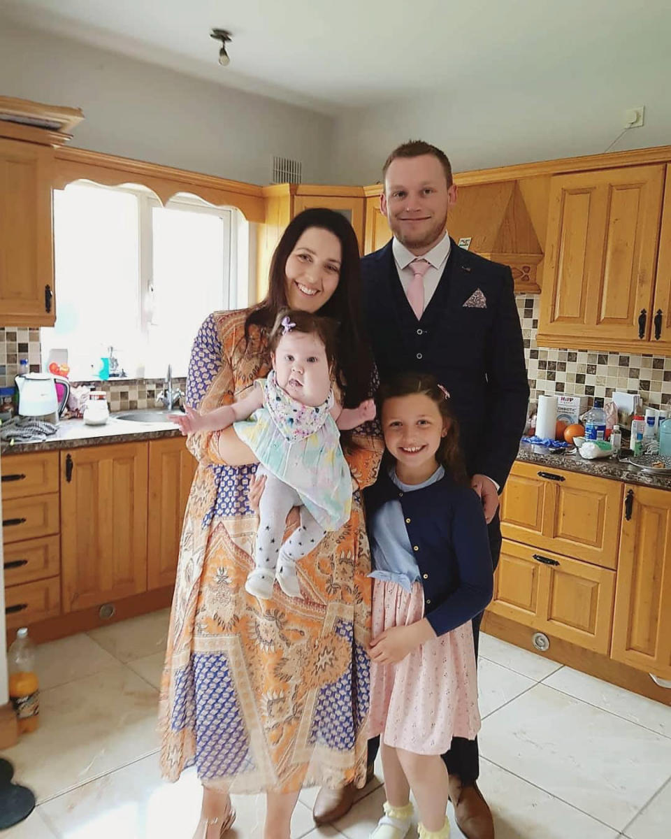 Evie Delaney pictured with mum Katie, dad Ciaran and sister Aila in their kitchen in Ireland.