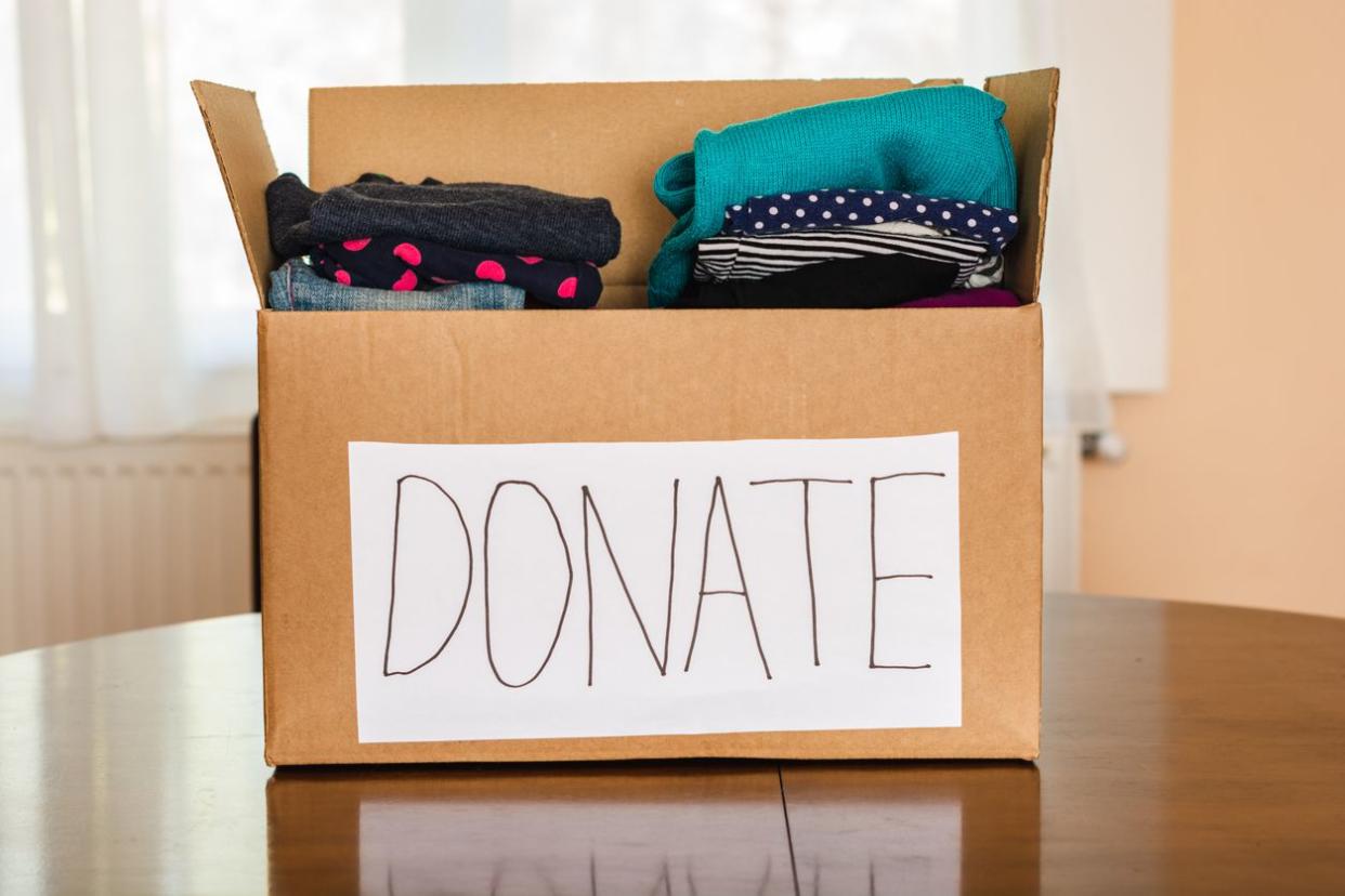 Clothes donation cardboard box full of clothes