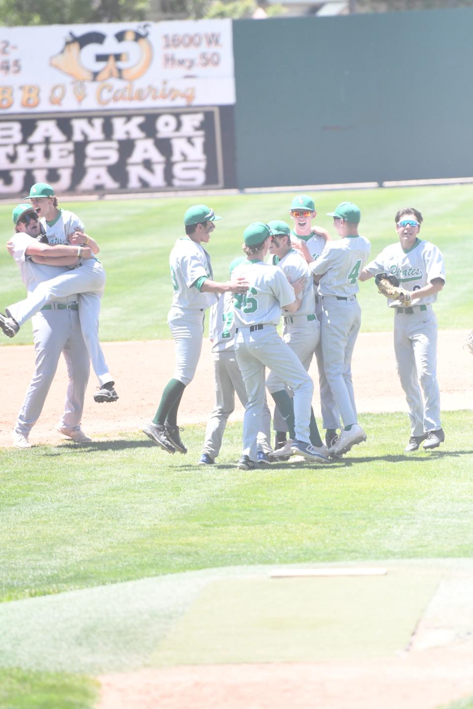 St. Mary's High School baseball players celebrate after defeating Rye 7-6 in the Class 2A Final 8 tournament on Friday, May 27, 2022, on Andenucio Field at the Runyon Sports Complex. [Chieftain photo/Jeff Letofsky]