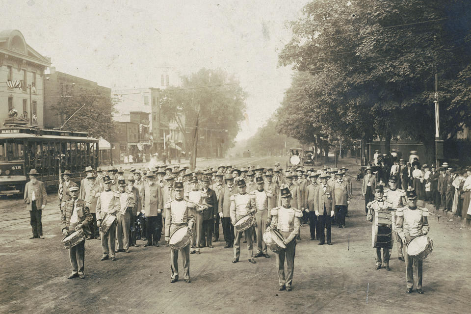 In this July 4, 1910 photo made available by the Library of Congress, United Confederate Veterans from the Civil War march with drummers down a street in Petersburg, Va. On July 4, 1776, the Continental Congress formally endorsed the Declaration of Independence. Celebrations began within days: parades and public readings, bonfires and candles and the firing of 13 musket rounds, one for each of the original states. Nearly a century passed before the country officially named its founding a holiday. (Library of Congress via AP)